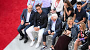Retired Hall of Fame New England Patriot player Tom Brady talks with Robert Kraft during an NFL statue unveiling