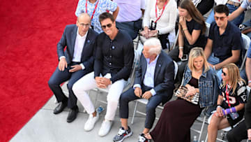 Retired Hall of Fame New England Patriot player Tom Brady talks with Robert Kraft during an NFL statue unveiling