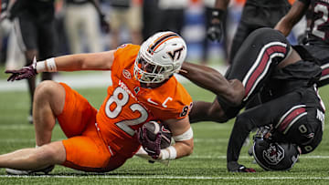 Aug 31, 2025; Atlanta, Ga. South Carolina linebacker Fred Johnson (0) tackles Virginia Tech tight end Benji Gosnell (82).