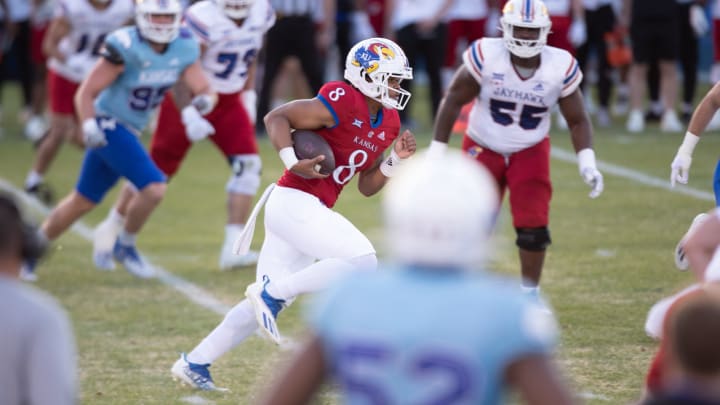 Kansas freshman quarterback Isaiah Marshall (8) takes off on a play during Friday's Spring Preview at Rock Chalk Park.