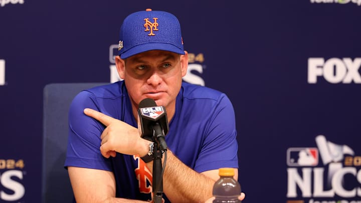 Oct 13, 2024; Los Angeles, California, USA; New York Mets manager Carlos Mendoza (64) speaks to the media before game one of the NLCS for the 2024 MLB Playoffs at Dodger Stadium. Mandatory Credit: Kiyoshi Mio-Imagn Images