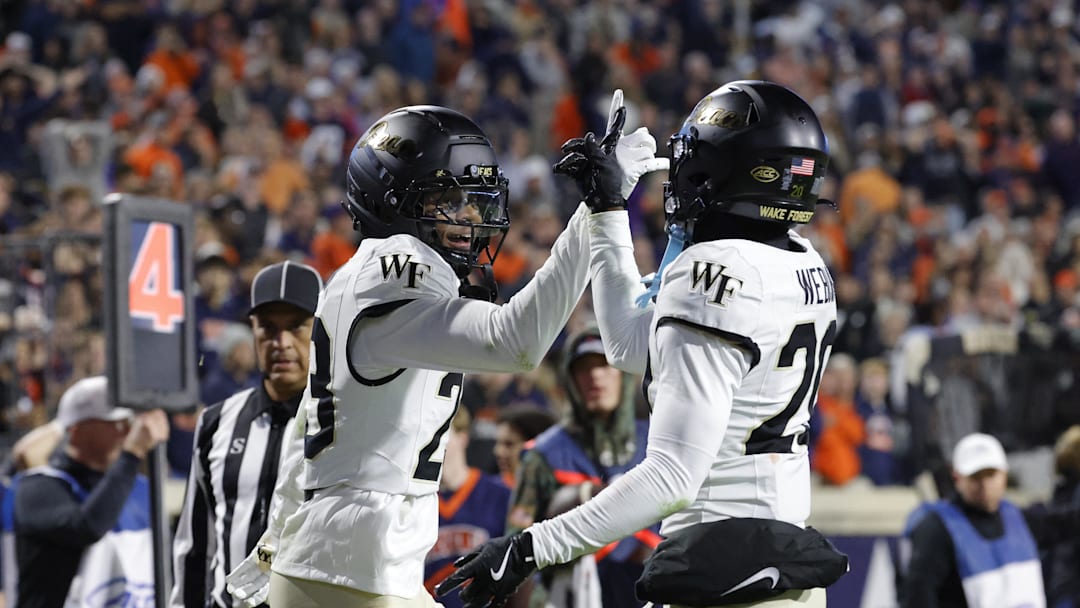 Nov 8, 2025; Charlottesville, Virginia, USA; Wake Forest Demon Deacons cornerback Braylon Johnson (23) celebrates with Demon Deacons safety Lardarius Webb Jr. (20) after blocking a touchdown pass during the final seconds of the second half against the Virginia Cavaliers at Scott Stadium. Mandatory Credit: Amber Searls-Imagn Images