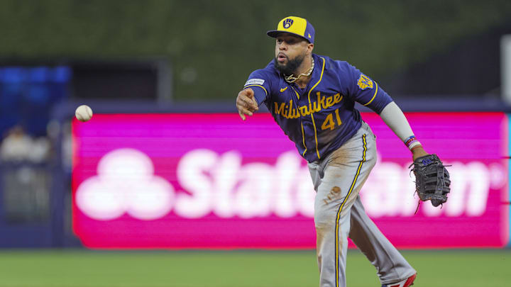 Sep 24, 2023; Miami, Florida, USA; Milwaukee Brewers first baseman Carlos Santana (41) tosses the baseball to relief pitcher J.B. Bukauskas (not pictured) and retires Miami Marlins catcher Jacob Stallings (not pictured) during the seventh inning at loanDepot Park. Mandatory Credit: Sam Navarro-Imagn Images