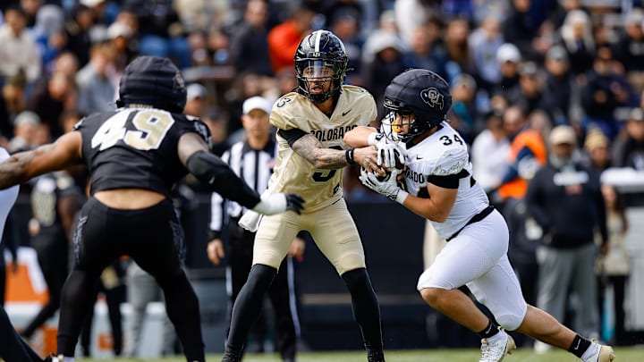 Apr 19, 2025; Boulder, CO, USA; Colorado Buffaloes quarterback Kaidon Salter (3) hands the ball off to running back Titus Bautista (34) as defensive end Quency Wiggins (49) defends during the spring game at Folsom Field. Mandatory Credit: Isaiah J. Downing-Imagn Images Apr 19, 2025; Boulder, CO, USA; Colorado Buffaloes quarterback Kaidon Salter (3) hands the ball off to running back Titus Bautista (34) as defensive end Quency Wiggins (49) defends during the spring game at Folsom Field. Mandatory Credit: Isaiah J. Downing-Imagn Images