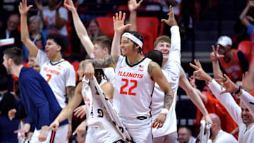 Dec 29, 2024; Champaign, Illinois, USA;  Illinois Fighting Illini players celebrate teammate  Kylan Boswell (4) after he recorded a triple double in a 117-64 win over the Chicago State Cougars at State Farm Center. Mandatory Credit: Ron Johnson-Imagn Images