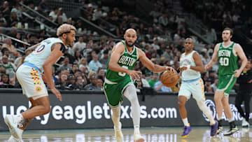 Mar 29, 2025; San Antonio, Texas, USA;  Boston Celtics guard Derrick White (9) dribbles against San Antonio Spurs forward Jeremy Sochan (10) in the second half at Frost Bank Center. Mandatory Credit: Daniel Dunn-Imagn Images