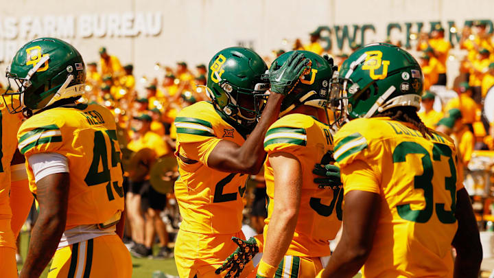Oct 4, 2025; Waco, Texas, USA; Baylor Bears safety Jacob Redding (38) celebrates with safeties Cameren Jenkins (23) and DJ Coleman (33) after returning an interception for a touchdown against the Kansas State Wildcats during the second half at McLane Stadium. Mandatory Credit: Chris Jones-Imagn Images