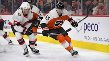 Mar 11, 2025; Philadelphia, Pennsylvania, USA; Ottawa Senators center Shane Pinto (12) and Philadelphia Flyers defenseman Rasmus Ristolainen (55) battle for the puck during the second period at Wells Fargo Center.