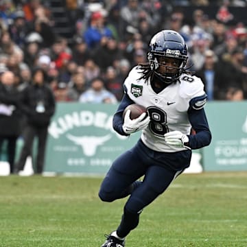 Dec 28, 2024; Boston, MA, USA; Connecticut Huskies wide receiver TJ Sheffield (8) runs the ball against the North Carolina Tar Heels  during the first half at Fenway Park. Mandatory Credit: Eric Canha-Imagn Images