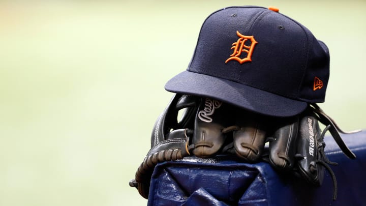 A Detroit Tigers hat and glove lay in the dugout at Tropicana Field