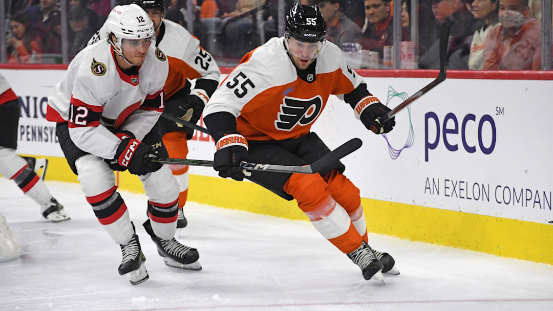 Mar 11, 2025; Philadelphia, Pennsylvania, USA; Ottawa Senators center Shane Pinto (12) and Philadelphia Flyers defenseman Rasmus Ristolainen (55) battle for the puck during the second period at Wells Fargo Center. Mandatory Credit: Eric Hartline-Imagn Images