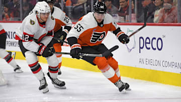 Mar 11, 2025; Philadelphia, Pennsylvania, USA; Ottawa Senators center Shane Pinto (12) and Philadelphia Flyers defenseman Rasmus Ristolainen (55) battle for the puck during the second period at Wells Fargo Center. Mandatory Credit: Eric Hartline-Imagn Images