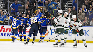 Nov 19, 2024; St. Louis, Missouri, USA;  St. Louis Blues left wing Jake Neighbours (63) is congratulated by teammates after scoring against the Minnesota Wild during the third period at Enterprise Center. Mandatory Credit: Jeff Curry-Imagn Images