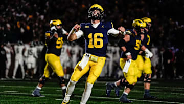 Michigan quarterback Davis Warren (16) celebrates a touchdown scored by tight end Colston Loveland during the second half against Michigan State at Michigan Stadium in Ann Arbor on Saturday, Oct. 26, 2024.