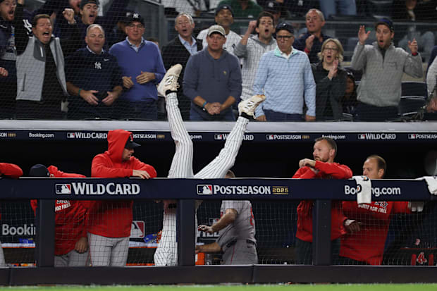 New York Yankees third baseman Ryan McMahon (19) falls into the Boston Red Sox dugout