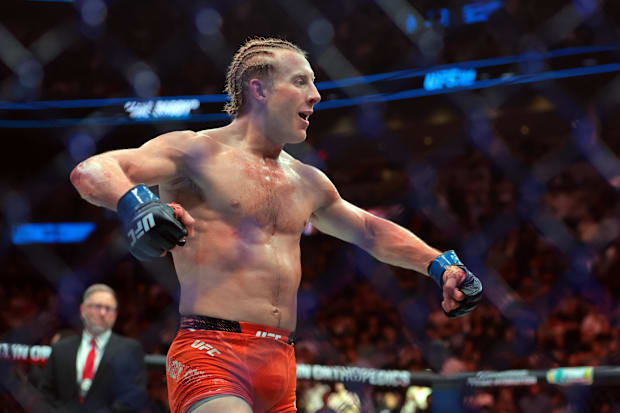 Paddy Pimblett (blue gloves) reacts after defeating Michael Chandler (not pictured) during UFC 314 at Kaseya Center. 