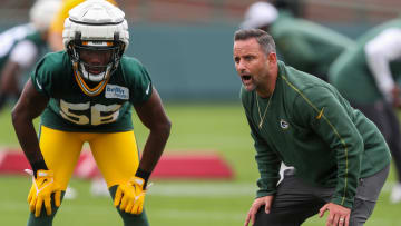 Green Bay Packers linebackers coach Anthony Campanile stands alongside Edgerrin Cooper at training camp.