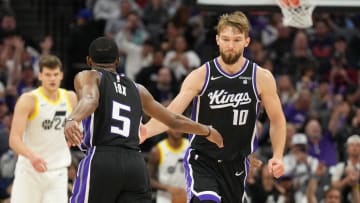 Mar 31, 2024; Sacramento, California, USA; Sacramento Kings guard De'Aaron Fox (5) is congratulated by forward Domantas Sabonis (10) after scoring during the third quarter against the Utah Jazz at Golden 1 Center. Mandatory Credit: Darren Yamashita-USA TODAY Sports