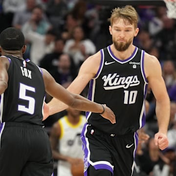 Mar 31, 2024; Sacramento, California, USA; Sacramento Kings guard De'Aaron Fox (5) is congratulated by forward Domantas Sabonis (10) after scoring during the third quarter against the Utah Jazz at Golden 1 Center. Mandatory Credit: Darren Yamashita-Imagn Images