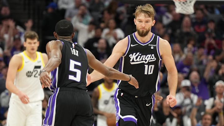 Mar 31, 2024; Sacramento, California, USA; Sacramento Kings guard De'Aaron Fox (5) is congratulated by forward Domantas Sabonis (10) after scoring during the third quarter against the Utah Jazz at Golden 1 Center. Mandatory Credit: Darren Yamashita-Imagn Images