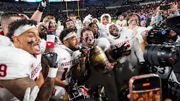 Indiana Hoosiers players celebrate with the Old Oaken Bucket on Saturday, Nov. 29, 2025, during the 100th annual Old Oaken Bucket game at Ross-Ade Stadium in West Lafayette. Indiana Hoosiers defeated the Purdue Boilermakers, 56-3.
