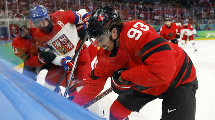 Feb 18, 2026; Milan, Italy; Mitch Marner of Canada battles for the puck against Radko Gudas of Czechia in a men's ice hockey quarterfinal during the Milano Cortina 2026 Olympic Winter Games at Milano Santagiulia Ice Hockey Arena. Mandatory Credit: Geoff Burke-Imagn Images