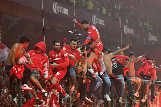 Toluca squad and supporters in celebration.