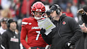 Nov 29, 2025; Louisville, Kentucky, USA;  Louisville Cardinals head coach Jeff Brohm talks with Louisville Cardinals quarterback Miller Moss (7) during the second half against the Kentucky Wildcats at L&N Federal Credit Union Stadium. Louisville defeated Kentucky 41-0. Mandatory Credit: Jamie Rhodes-Imagn Images