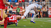Jan 28, 2024; Santa Clara, California, USA; Detroit Lions wide receiver Jameson Williams (9) runs with the ball for a touchdown San Francisco 49ers linebacker Dre Greenlaw (57) during the first half of the NFC Championship football game at Levi's Stadium. Mandatory Credit: Kelley L Cox-Imagn Images
