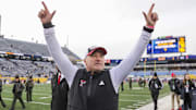 Texas Tech Red Raiders head coach Joey McGuire celebrates with fans after defeating the West Virginia Mountaineers at Milan Puskar Stadium.