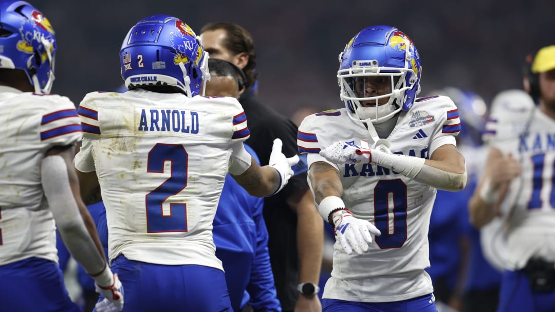 Kansas football wide receivers Lawrence Arnold (2) and Quentin Skinner (0)