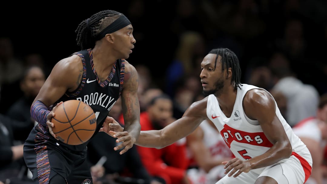 Nov 11, 2025; Brooklyn, New York, USA; Brooklyn Nets guard Terance Mann (14) controls the ball against Toronto Raptors guard Immanuel Quickley (5) during the second quarter at Barclays Center. Mandatory Credit: Brad Penner-Imagn Images