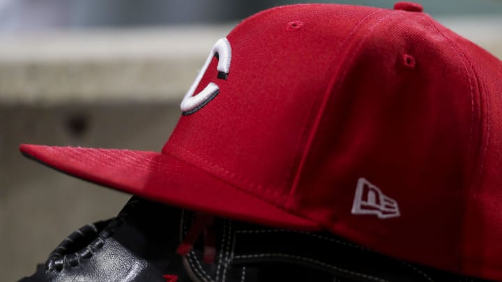 Jul 5, 2022; Cincinnati, Ohio, USA; The hat and glove of Cincinnati Reds right fielder Tyler Naquin (12) during the sixth inning in the game against the New York Mets at Great American Ball Park. Mandatory Credit: Katie Stratman-USA TODAY Sports