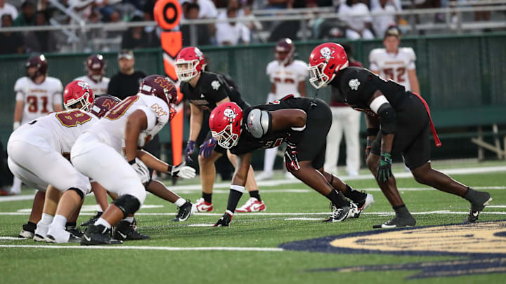 Savannah Christian's Elijah Griffin and LaDamion Guyton prepare for the snap on Friday, August 23, 2024 at Pooler Stadium.