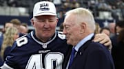 Dallas Cowboys owner Jerry Jones talks with Bill Bates, former player, before the game against the Washington Commanders