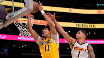 Mar 19, 2025; Los Angeles, California, USA;  Denver Nuggets forward Michael Porter Jr. (1) defends a shot by Los Angeles Lakers center Jaxson Hayes (11) in the first half at Crypto.com Arena. Mandatory Credit: Jayne Kamin-Oncea-Imagn Images