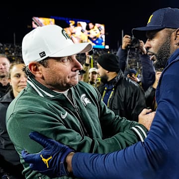 Michigan State head coach Jonathan Smith, left, shakes hands with head coach Sherrone Moore after 24-17 loss at Michigan Stadium in Ann Arbor on Saturday, Oct. 26, 2024.
