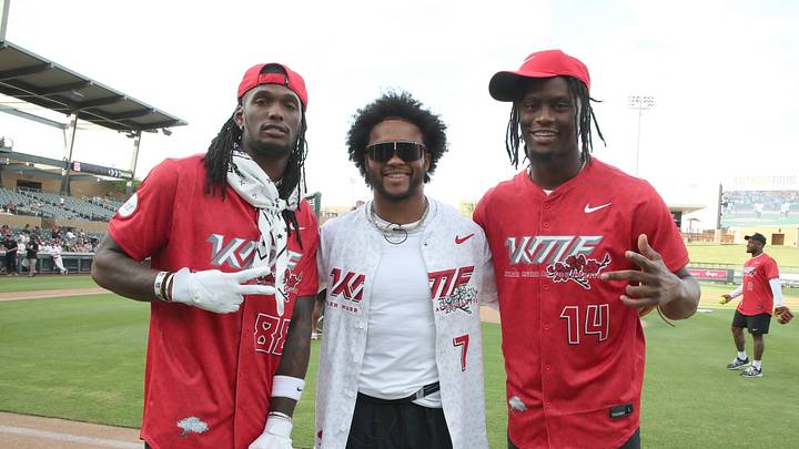 Cowboys WRs CeeDee Lamb (L) and George Pickens (R) pose with Cardinals QB Kyler Murray at Murray's charity softball event