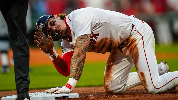 Boston Red Sox outfielder Jarren Duran (16) after sliding into third base against the Tampa Bay Rays in the third inning at Fenway Park.