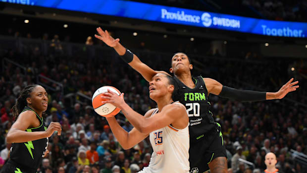 A photo of Alyssa Thomas attacking the basket against Seattle