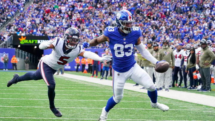 Nov 13, 2022; East Rutherford, NJ, USA;  New York Giants tight end Lawrence Cager (83) scores a touchdown as Houston Texans safety Jalen Pitre (5) defends during the first quarter at MetLife Stadium. Mandatory Credit: Robert Deutsch-USA TODAY Sports