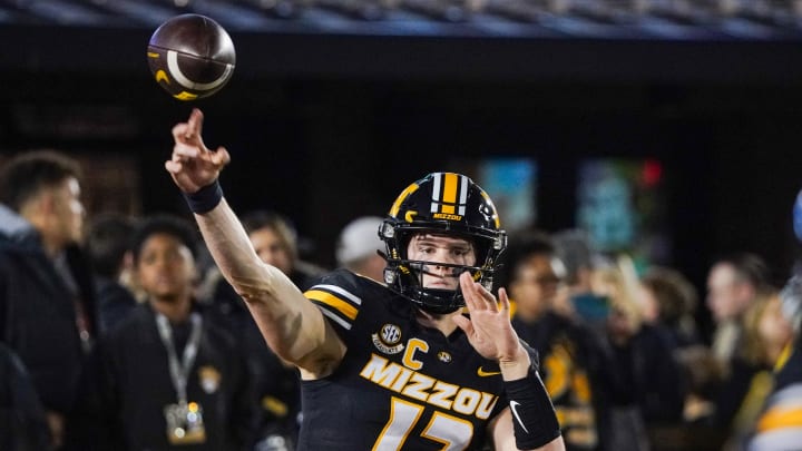 Nov 18, 2023; Columbia, Missouri, USA; Missouri Tigers quarterback Brady Cook (12) warms up against the Florida Gators prior to a game at Faurot Field at Memorial Stadium. Mandatory Credit: Denny Medley-USA TODAY Sports