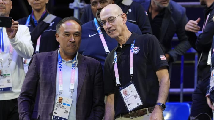 NBA commissioner Adam Silver talks to International Basketball Federation board member Mark Tatum in the fourth quarter between the United States and Puerto Rico during the Paris 2024 Olympic Summer Games.