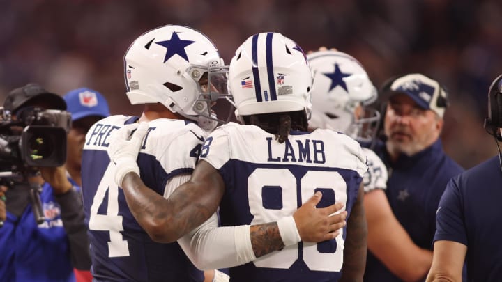 Dallas Cowboys wide receiver CeeDee Lamb (88) and quarterback Dak Prescott (4) talk during the game against the Washington Commanders.