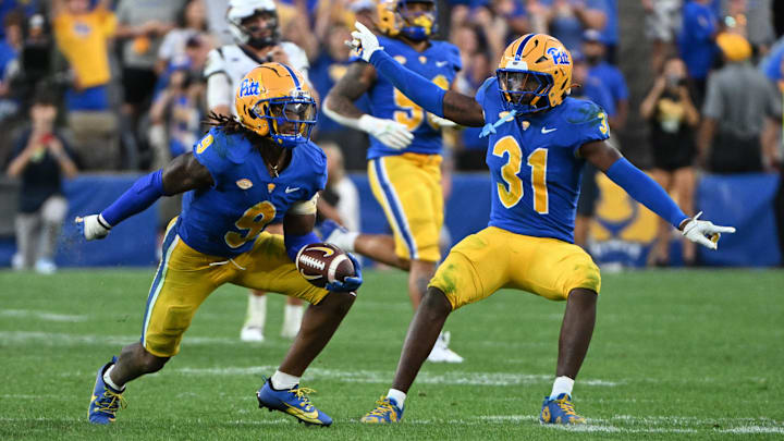 Sep 14, 2024; Pittsburgh, Pennsylvania, USA; Pittsburgh Panthers linebacker Kyle Louis celebrates with linebacker Rasheem Biles (31) after intercepting West Virginia Mountaineers quarterback Garrett Greene (6) in the fourth quarter at Acrisure Stadium. Mandatory Credit: Barry Reeger-Image Images