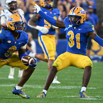 Sep 14, 2024; Pittsburgh, Pennsylvania, USA; Pittsburgh Panthers linebacker Kyle Louis celebrates with linebacker Rasheem Biles (31) after intercepting West Virginia Mountaineers quarterback Garrett Greene (6) in the fourth quarter at Acrisure Stadium. Mandatory Credit: Barry Reeger-Image Images