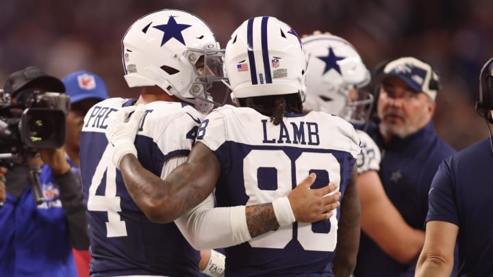 Nov 23, 2023; Arlington, Texas, USA; Dallas Cowboys wide receiver CeeDee Lamb (88) and quarterback Dak Prescott (4) talk during the game against the Washington Commanders at AT&T Stadium. 