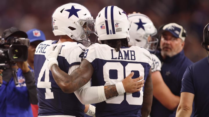 Nov 23, 2023; Arlington, Texas, USA; Dallas Cowboys wide receiver CeeDee Lamb (88) and quarterback Dak Prescott (4) talk during the game against the Washington Commanders at AT&T Stadium. 