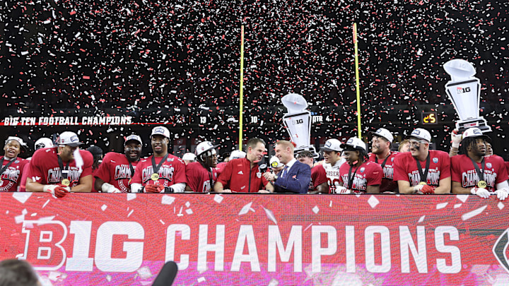 Dec 6, 2025; Indianapolis, IN, USA; Indiana Hoosiers head coach Curt Cignetti celebrates with players on the podium after defeating the Ohio State Buckeyes in the 2025 Big Ten championship game at Lucas Oil Stadium. Mandatory Credit: Trevor Ruszkowski-Imagn Images