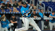 Jul 20, 2025; Miami, Florida, USA; Miami Marlins catcher Agustin Ramirez (50) hits a single against the Kansas City Royals during the first inning at loanDepot Park. Mandatory Credit: Sam Navarro-Imagn Images